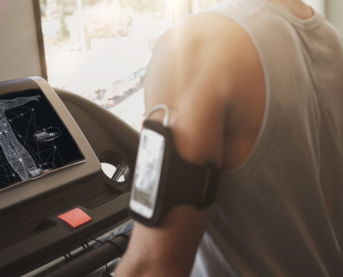 A person using a treadmill and a smart device